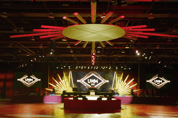 Large stage at a corporate party with custom decorations and a light wall