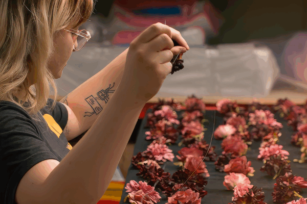 Close up of designer creating custom floral arrangements for the 2023 Book Tower Celebration.