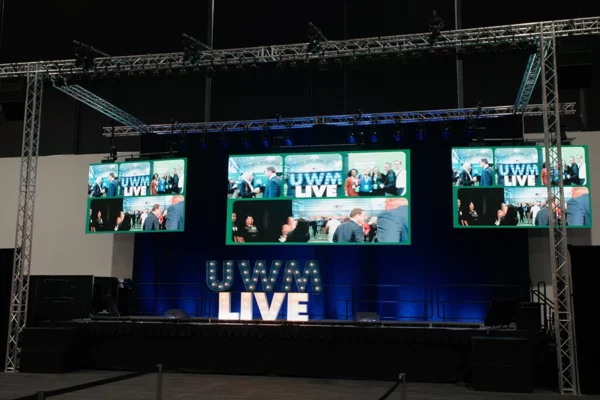 Photo opp featuring custom fabricated lighted logo and video screen, trusses and stage
