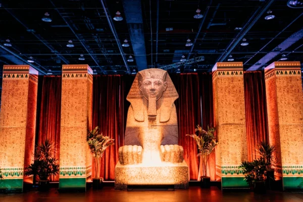 Wide venue shot of Egyptian-themed UWM holiday party set design