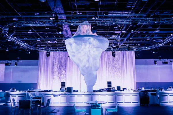 Giant suspended iceberg sculpture above UWM holiday party dance floor