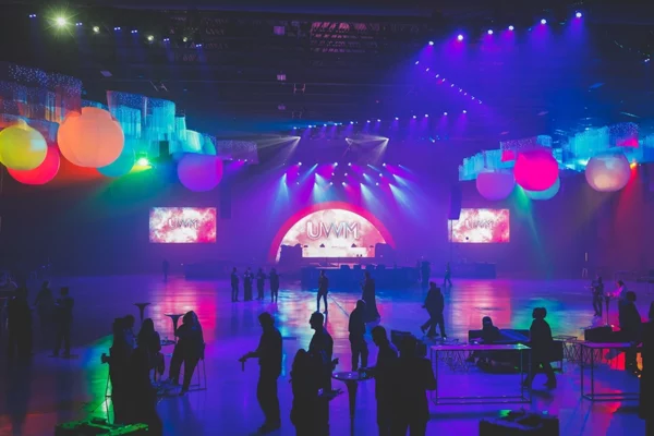 UWM holiday party ballroom with colorful globe lights and stage