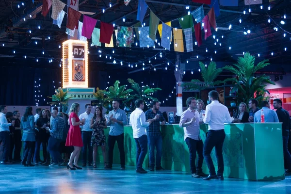 Cantina bar with guests and colorful bunting at UWM holiday party