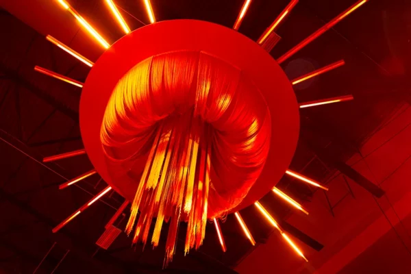 Red sunburst ceiling installation at UWM holiday party