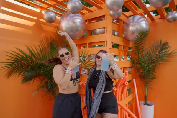 Party goers dance in a custom fabricated photo opp
