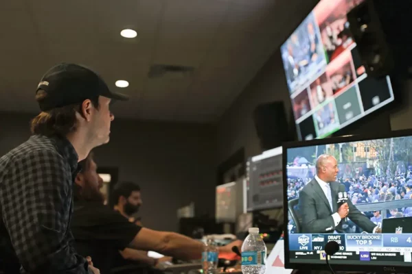 Control room with multiple monitors displaying NFL Draft coverage
