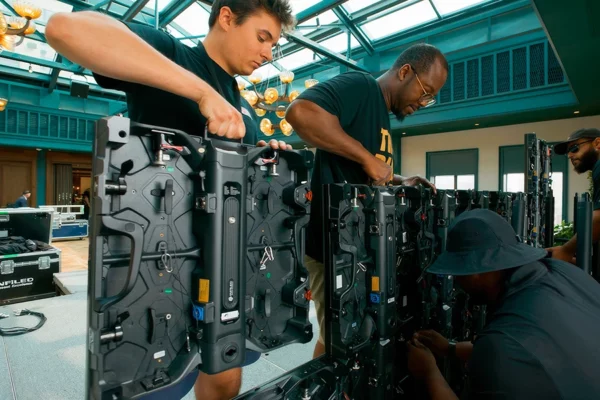 Production crew installing LED panels for Book Tower event