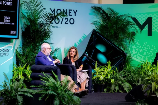 Two speakers on plant-framed Money 20/20 conference stage