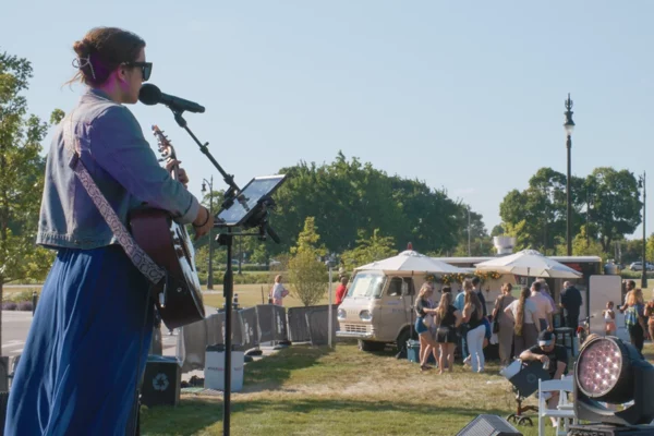 Musician performing outdoors during the day