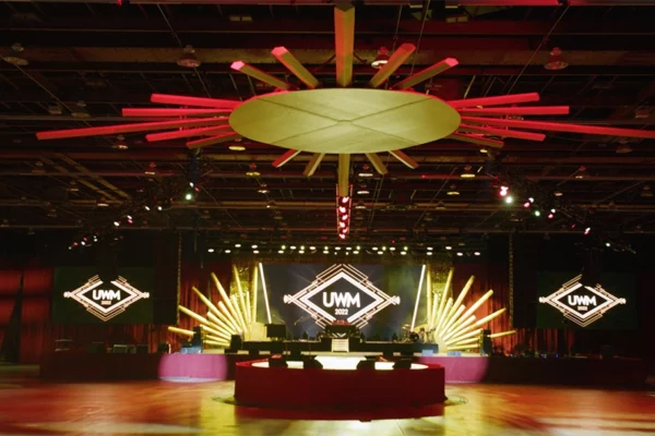 UWM 2022 holiday party stage with sunburst ceiling installation