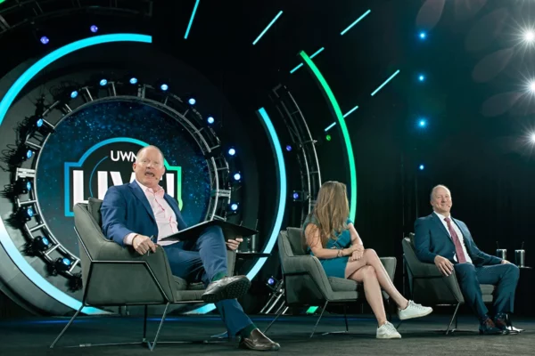 Speakers sit on stage