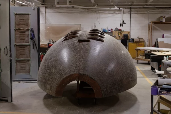arge fiberglass football prop under construction in Display Group fabrication shop