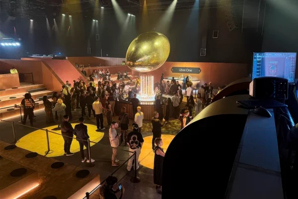 Uber One Super Bowl party guests surrounding gold football centerpiece