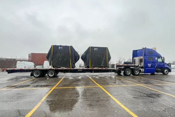 Oversized football props loaded on flatbed truck for Super Bowl transport