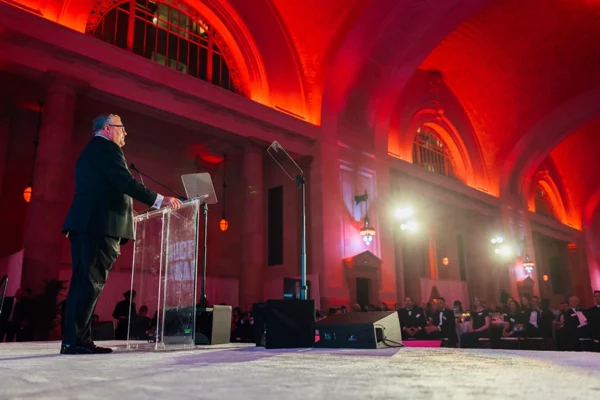 Speaker at podium on Automotive Hall of Fame stage at Michigan Central