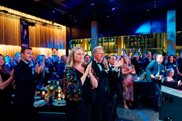 Guests giving a standing ovation at Automotive Hall of Fame ceremony