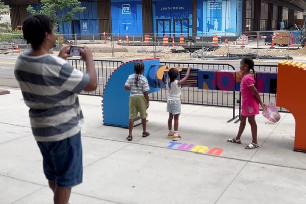 Children photographed in front of Bedrock streetscape sculpture in Detroit